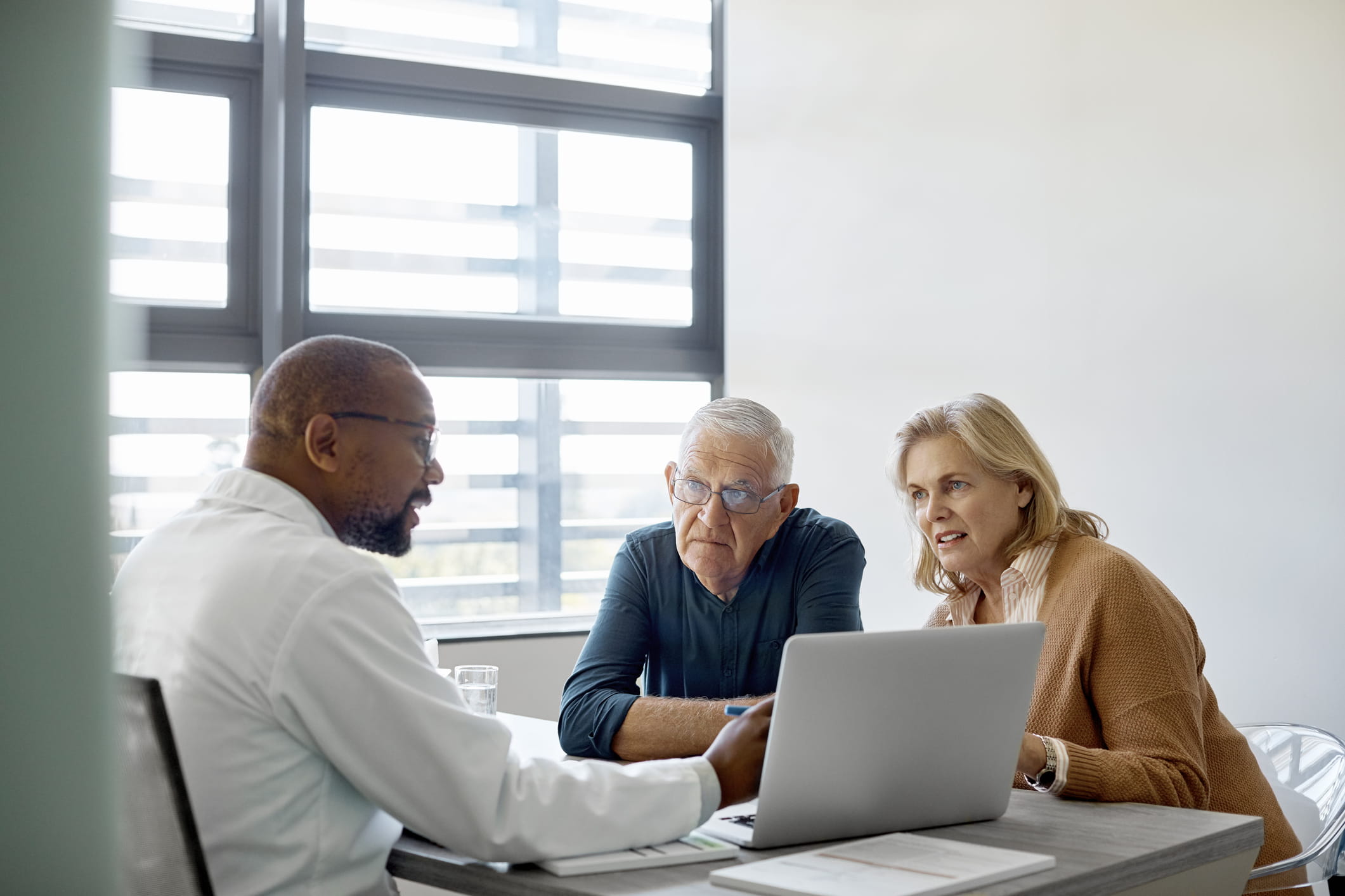 doctor-having-an-appointment-with-couple-will-I-lose-my-job-in-a-recession