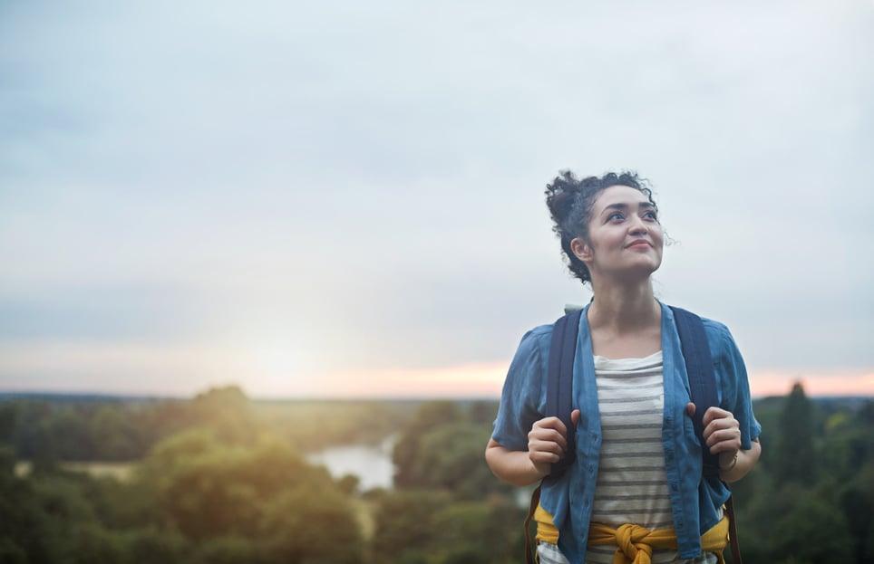 female-hiker-climbing-hill-purpose-vs-mission-vision