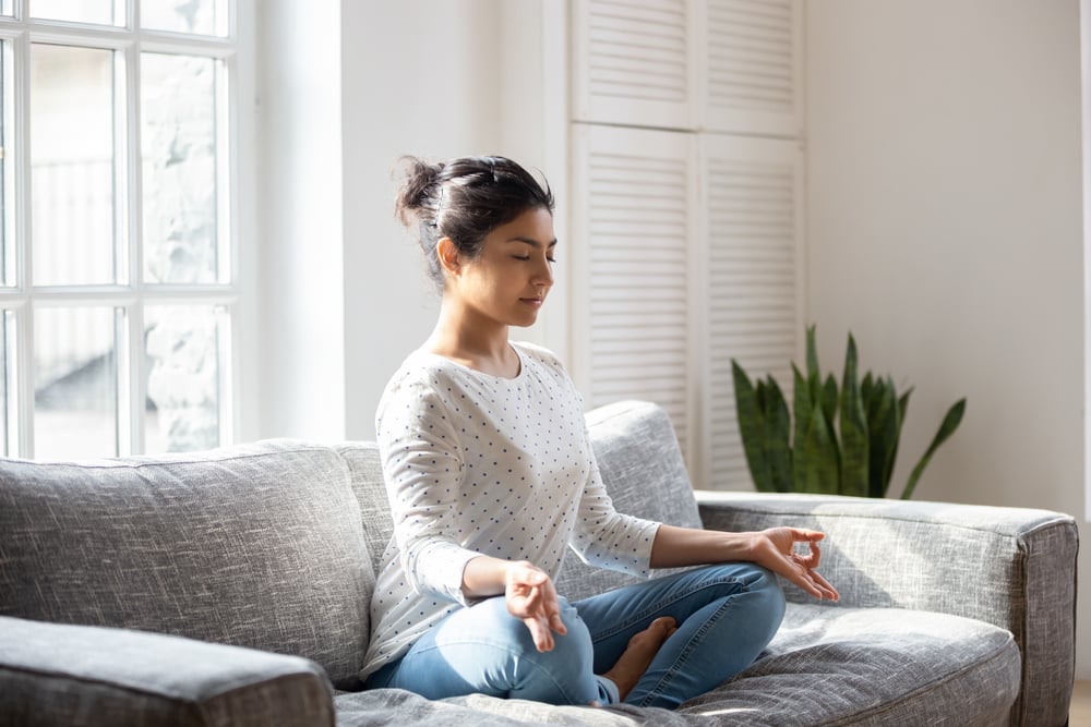 female-sitting-on-couch-in-lotus-yoga-position-what-to-do-when-you-mess-up-at-work