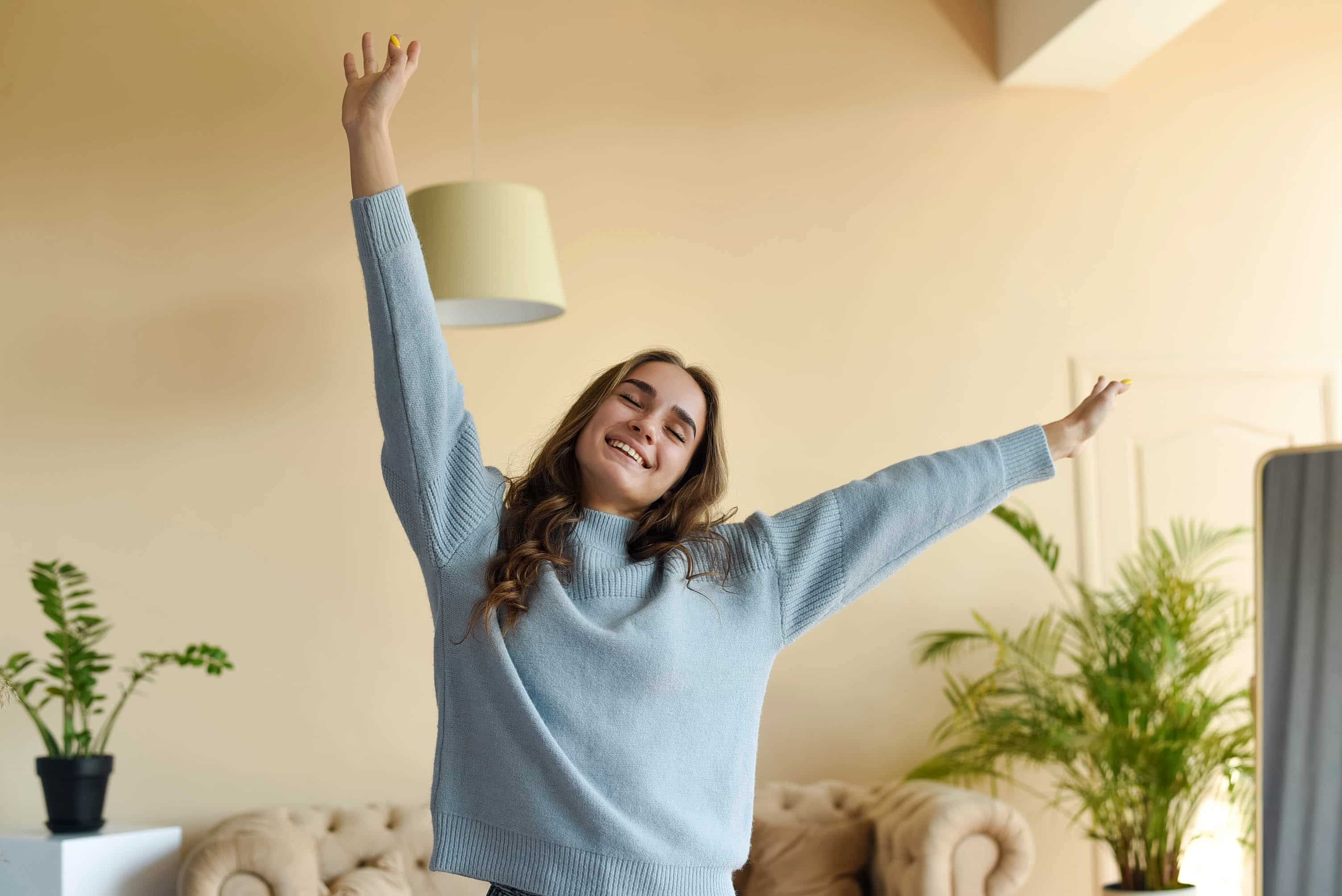 girl-in-a-blue-sweater-stretching-in-the-room-progressive-muscle-relaxation-techniques
