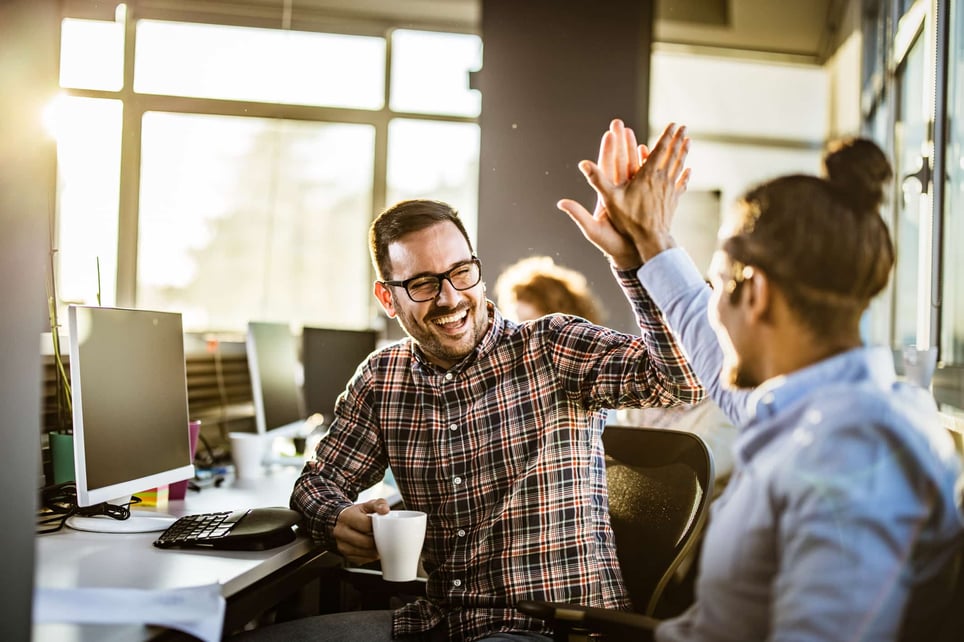 happy-male-programmers-giving-each-other-high-five-at-office-social-skills-examples