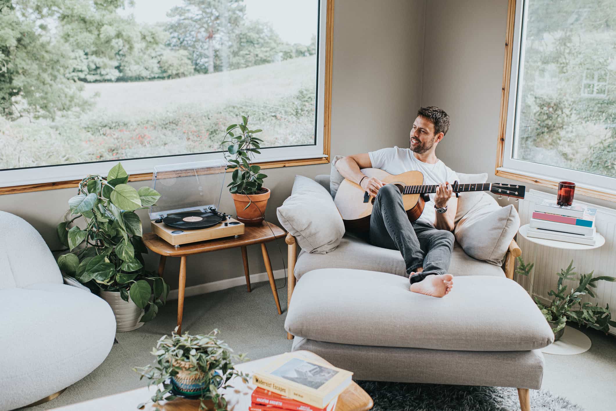 happy-man-practicing-with-his-guitar-what-causes-perfectionism