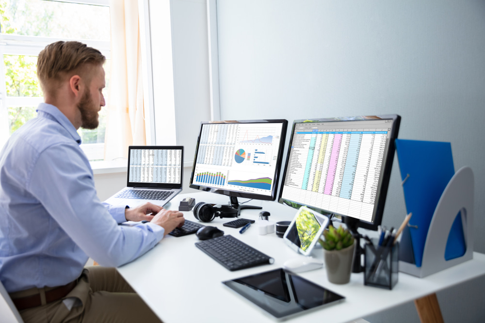 male-data-scientist-working-with-3-screens-most-in-demand-jobs