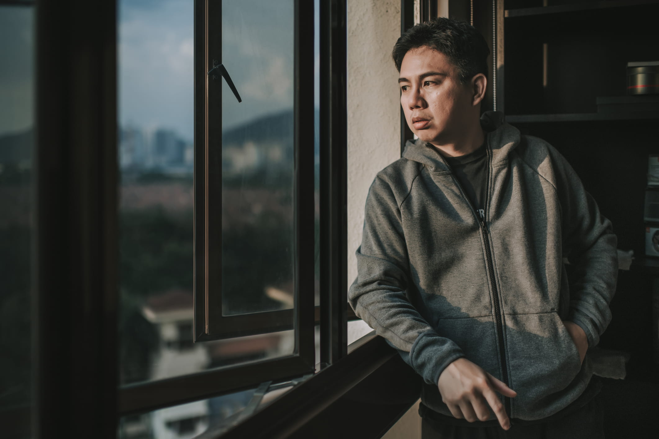 man-looking-outside-his-window-social-isolation-symptoms