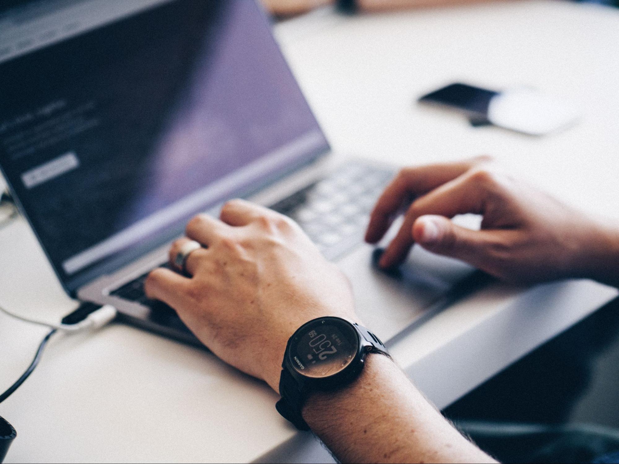 man-on-laptop-wearing-stress-tracker-watch