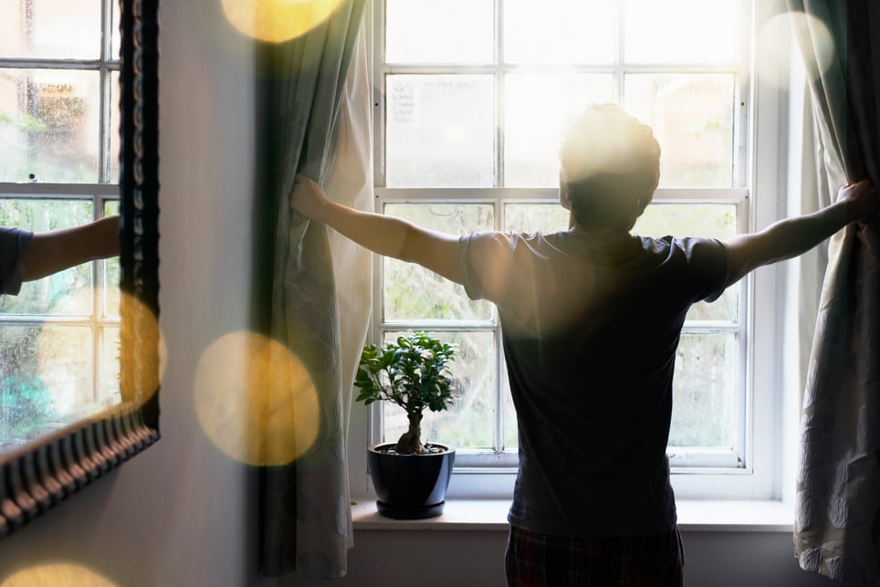 man-opening-curtains-goals-for-self-improvement