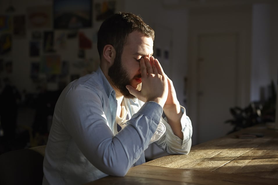 man-sitting-at-kitchen-table-stressors-examples