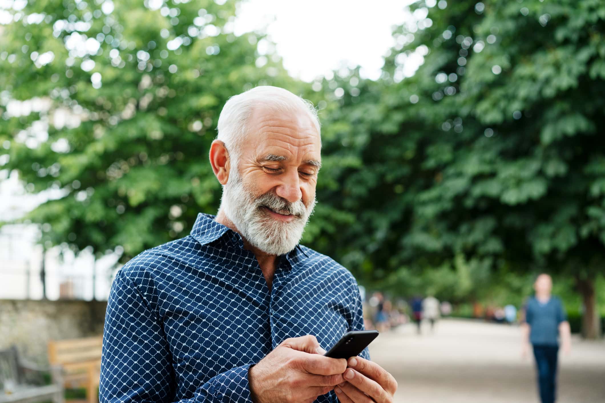 man-smiling-at-his-phone-what-is-mindfulness