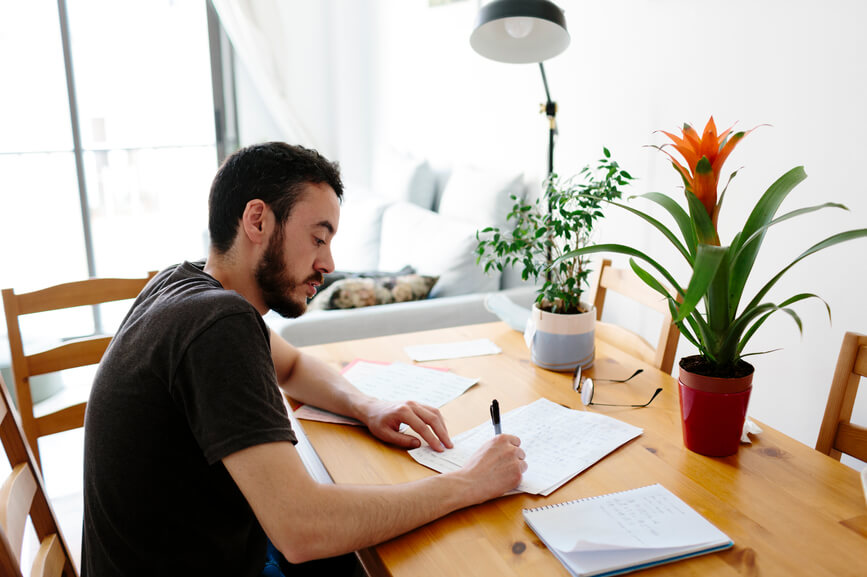 organized-man-writing-at-desk-mental-clarity