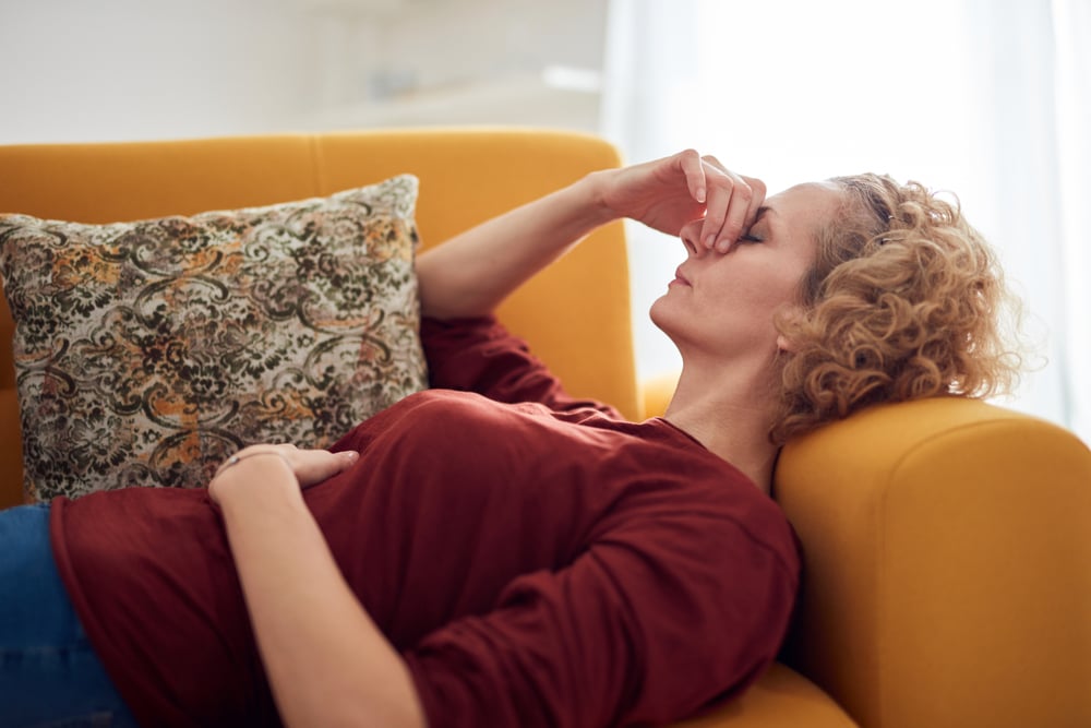 tired-woman-lying-on-couch-effects-of-low-resiliencegydF4y2Ba