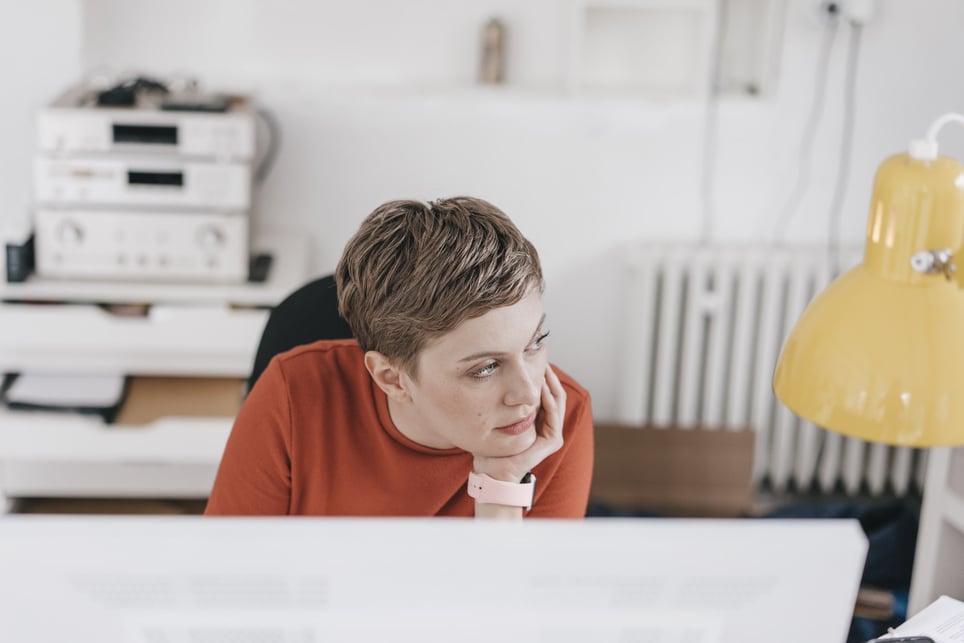 woman-at-desk-in-office-thinking