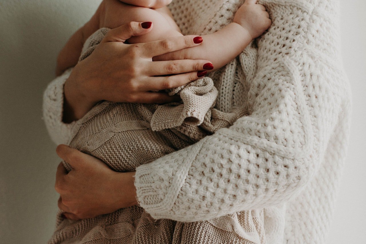 woman-holding-her-baby-in-arms