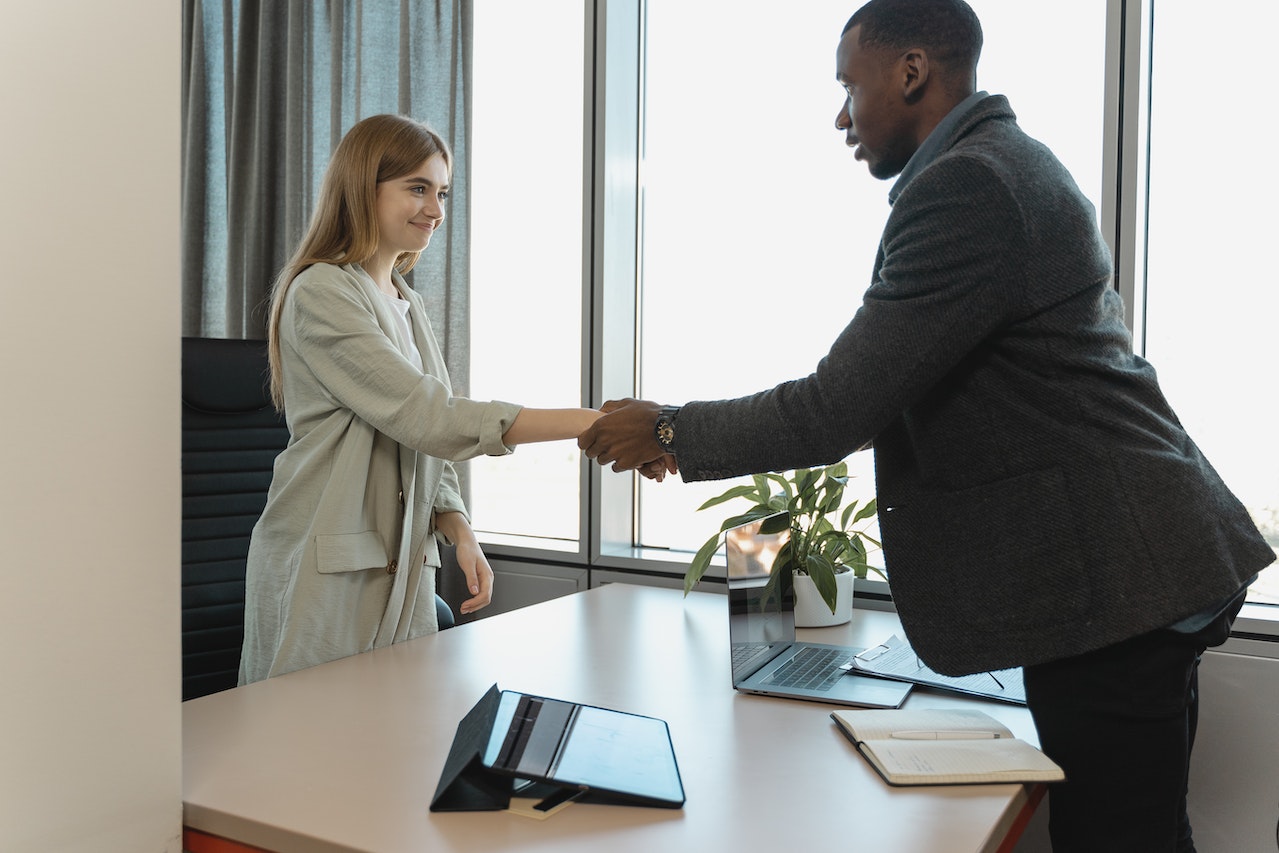 woman-shaking-hands-with-man-in-office-for-interview