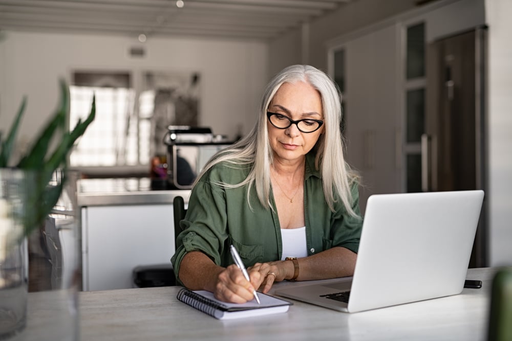 woman-writing-on-her-notebook-how-to-write-a-cover-letter
